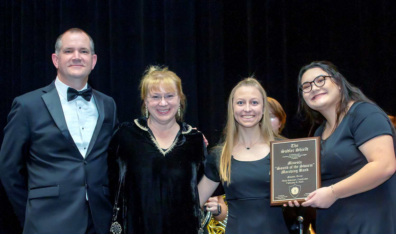 The Mineola High School Sound of the Swarm band was officially presented the Sudler Shield, a prestigious national award, during last Thursday’s performance in Lindale, when the band played the concert that it will give this week at the Texas Music Educators Association convention in San Antonio as the state honor band. Two members will also take part in all-state band clinics and concerts. Shown, from left, Director Chris Brannan, presenter Amanda Drinkwater-fine arts director for Lewisville ISD and drum majors Tristan Kirk and Emily Phonsnasinh.